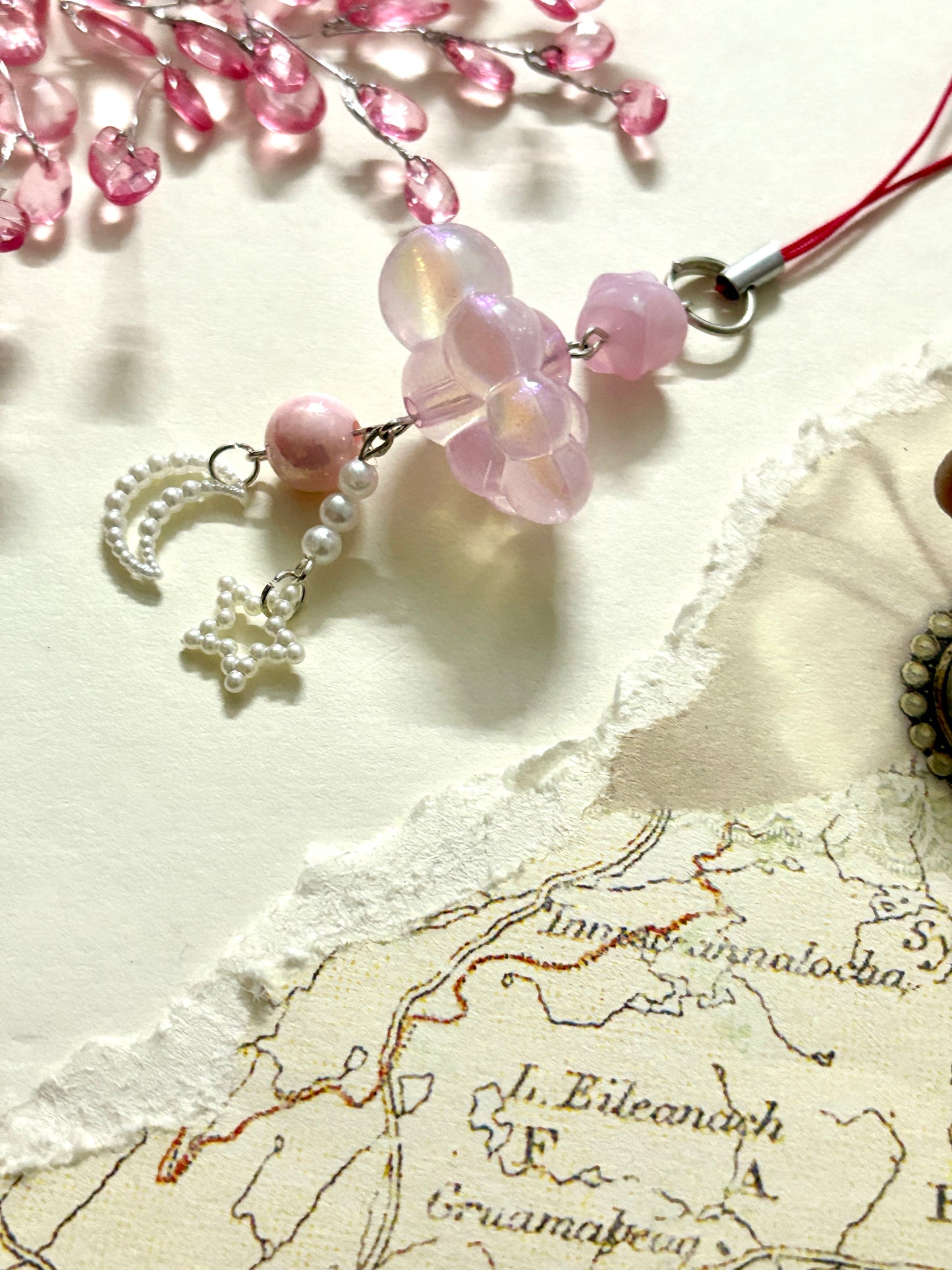 Aesthetic beaded phone charm with cloud-shaped beads, moon and star danglers, and pearls. A soft dreamy accessory for phones, bags, or gifting.