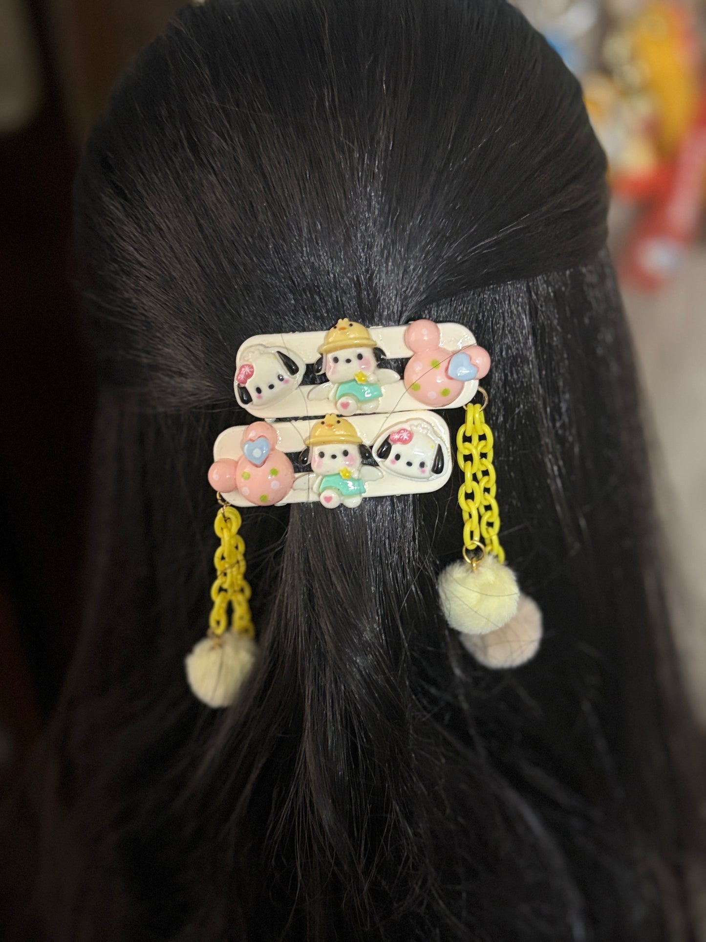 Pastel Minnie Mouse hair clips with yellow chain dangles and fluffy pom poms—adorable cartoon-themed hair accessories ideal for kids’ fashion and fun hairstyles.