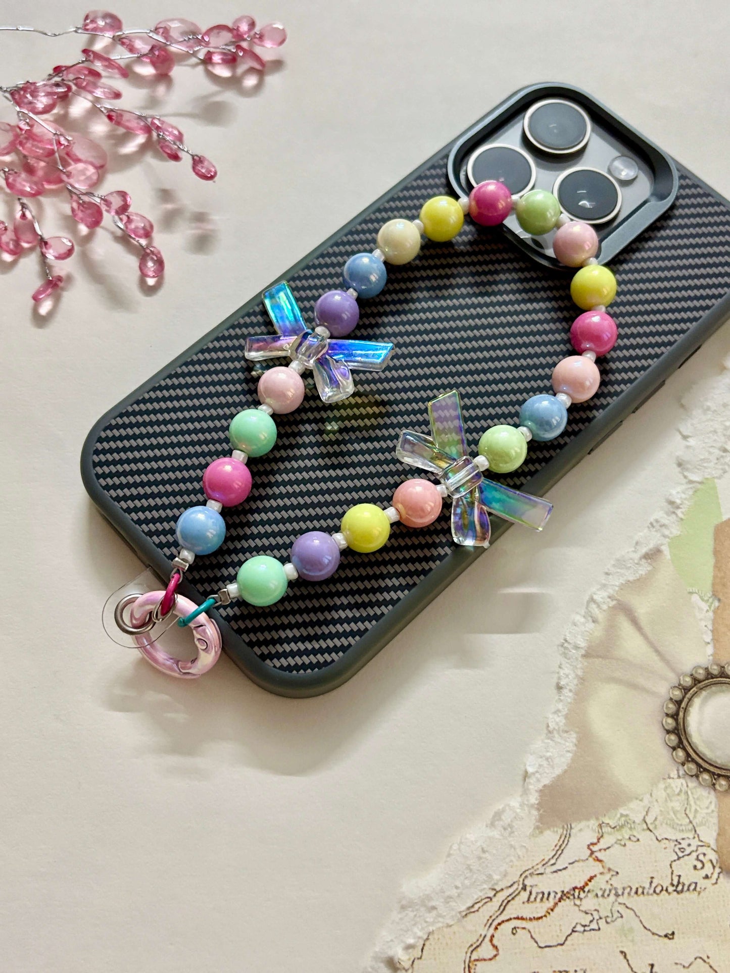 “Handmade colorful beaded phone charm with rainbow acrylic bow beads