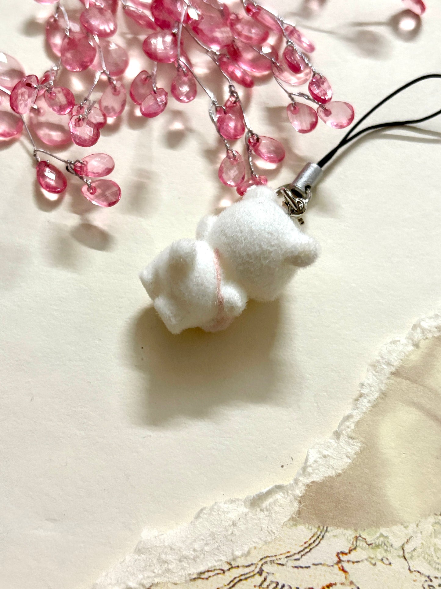 Kawaii mini plush bear phone charm in white with pink details, perfect for keychains, bags or phones. Soft and adorable for gifting or collecting.