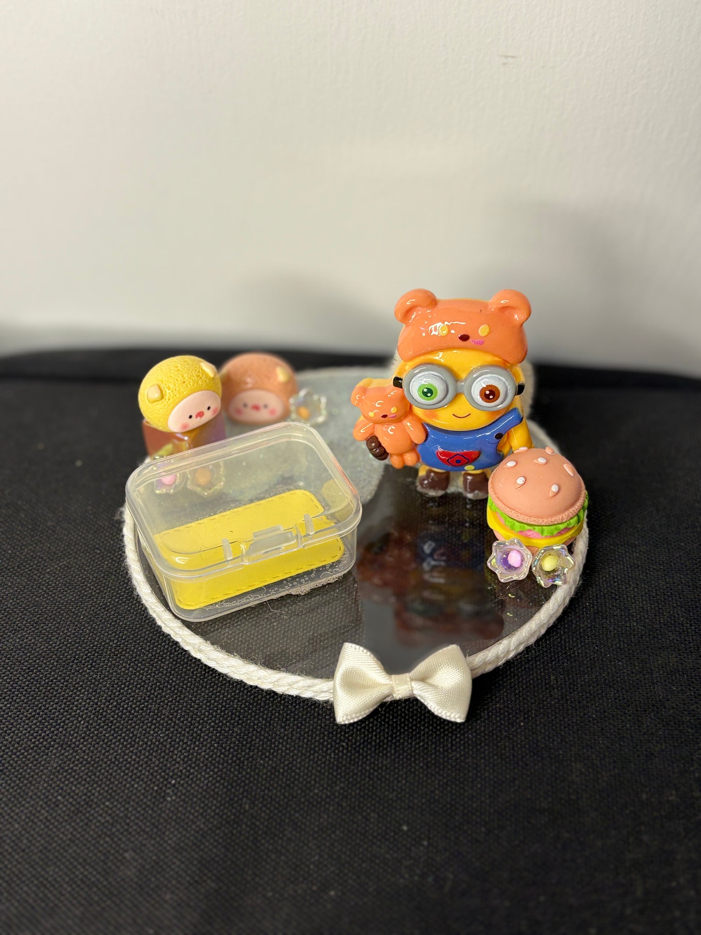 A handcrafted miniature platter featuring a minion-inspired character and cute accessories, designed for holding small items like rings, earrings, toffees, or trinkets; ideal as a decorative tabletop organizer or gift.