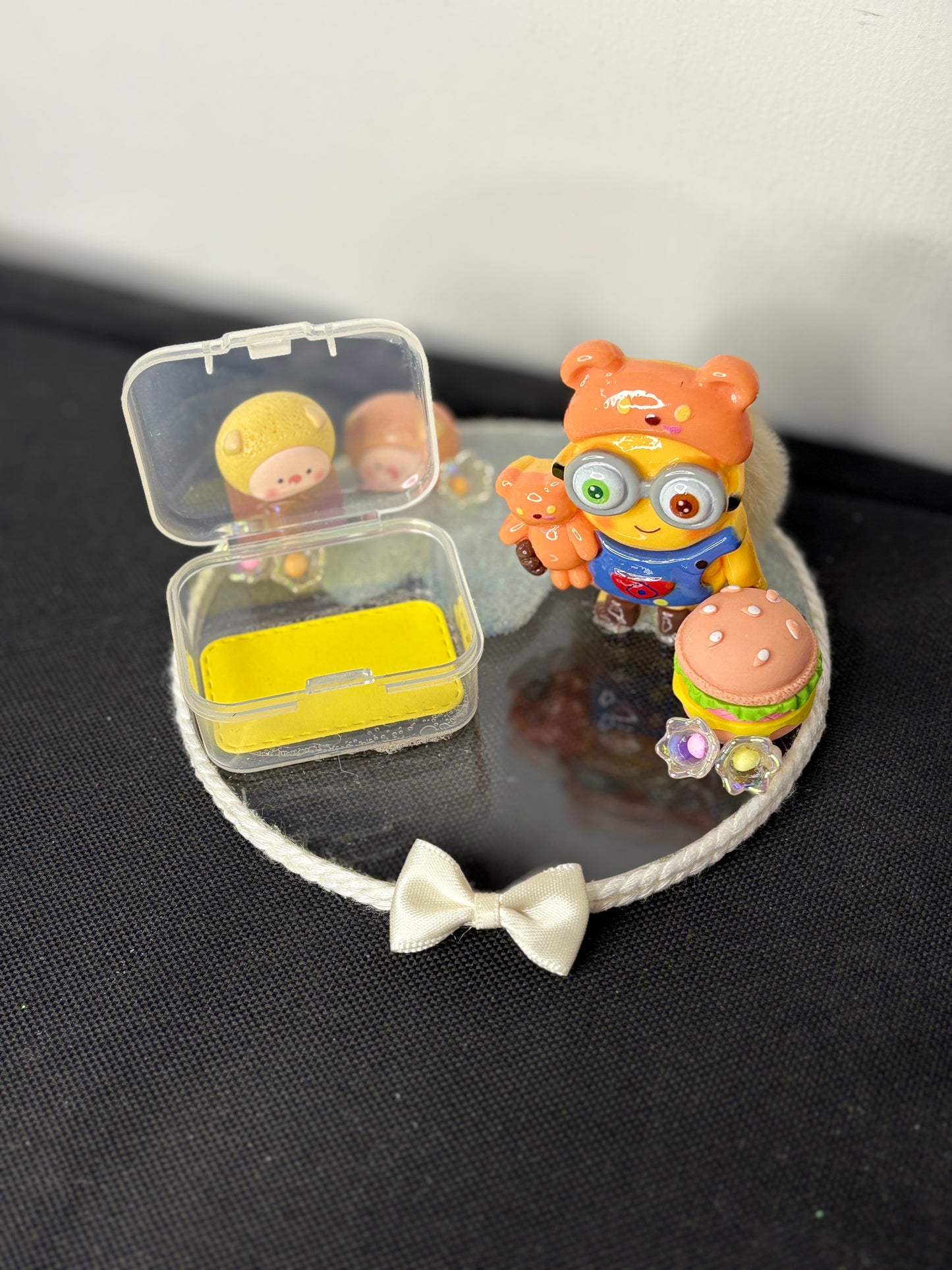 A handcrafted miniature platter featuring a minion-inspired character and cute accessories, designed for holding small items like rings, earrings, toffees, or trinkets; ideal as a decorative tabletop organizer or gift.