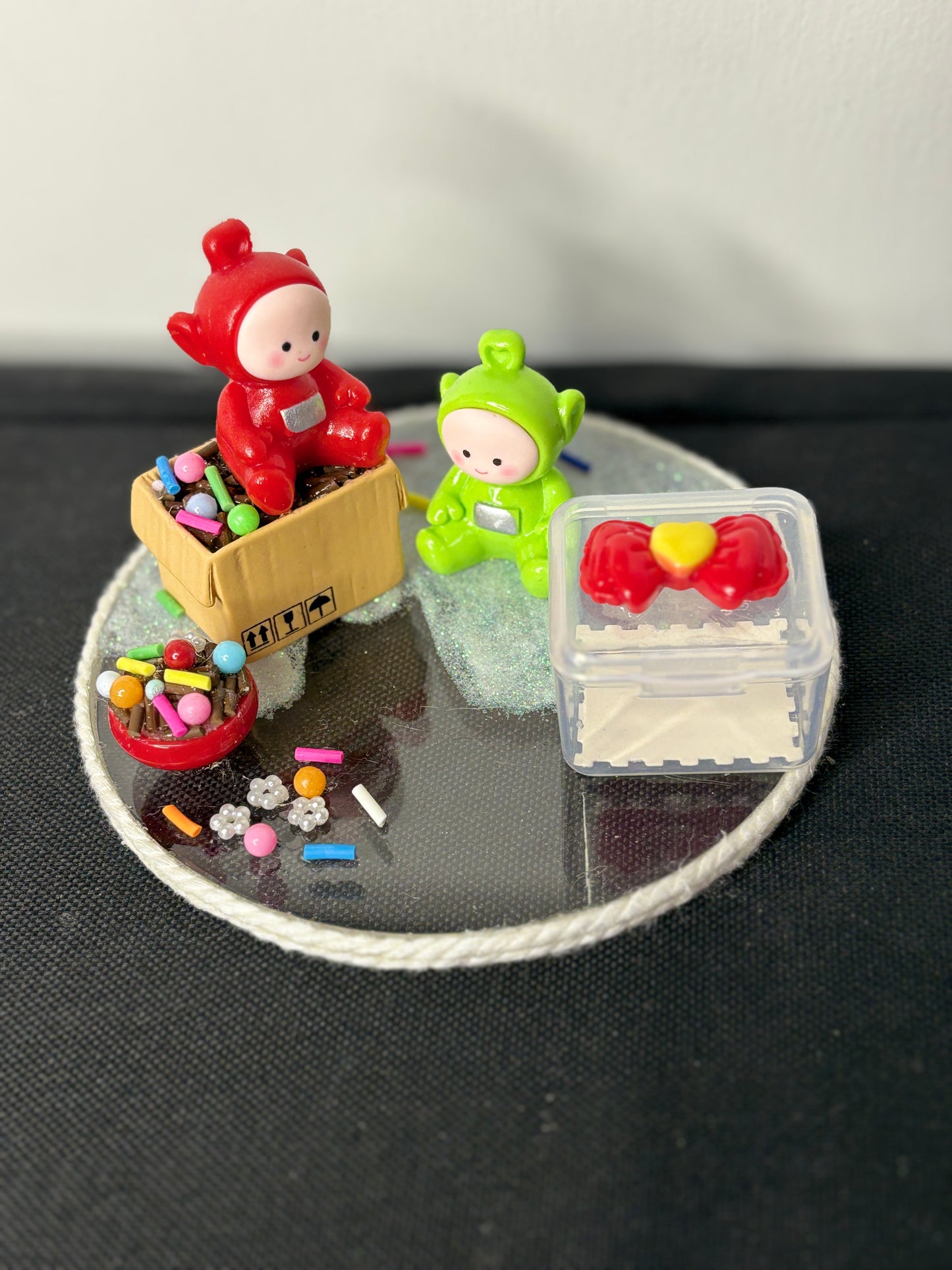 A handmade miniature platter featuring cartoon-inspired characters with playful accessories and candy-themed details, designed for holding small items like rings, earrings, toffees, or trinkets; perfect for decor or gifting.