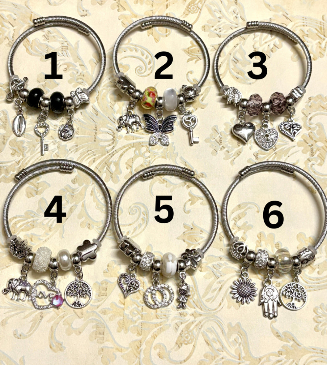 Stylish silver Pandora-inspired charm bracelets with hearts, butterflies, and trees. Elegant adjustable bangles perfect for gifting or everyday use. 