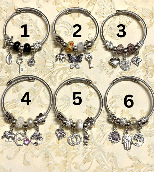 Stylish silver Pandora-inspired charm bracelets with hearts, butterflies, and trees. Elegant adjustable bangles perfect for gifting or everyday use. 