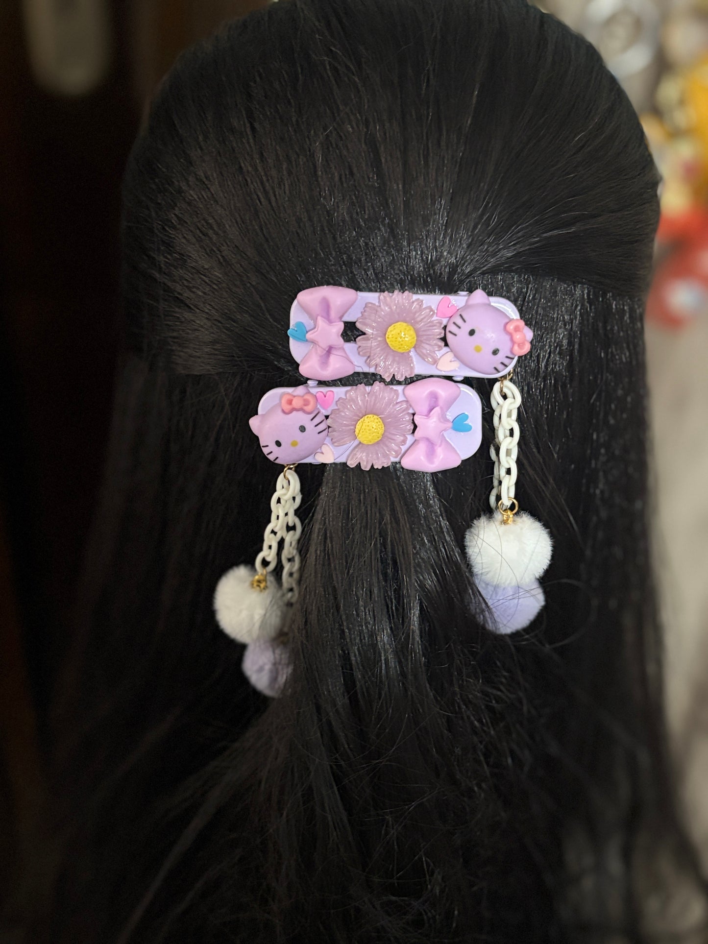 Cute pastel hair clips featuring Hello Kitty, floral accents, stars, hearts, and dangling Pom Poms. A kawaii accessory set perfect for girls and young teens.