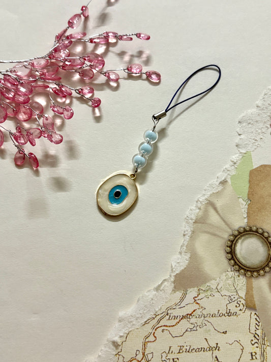 Blue evil eye phone charm with pastel beads and a black strap — a stylish and symbolic accessory for phones, pouches, or keychains, promoting good luck and protection.
