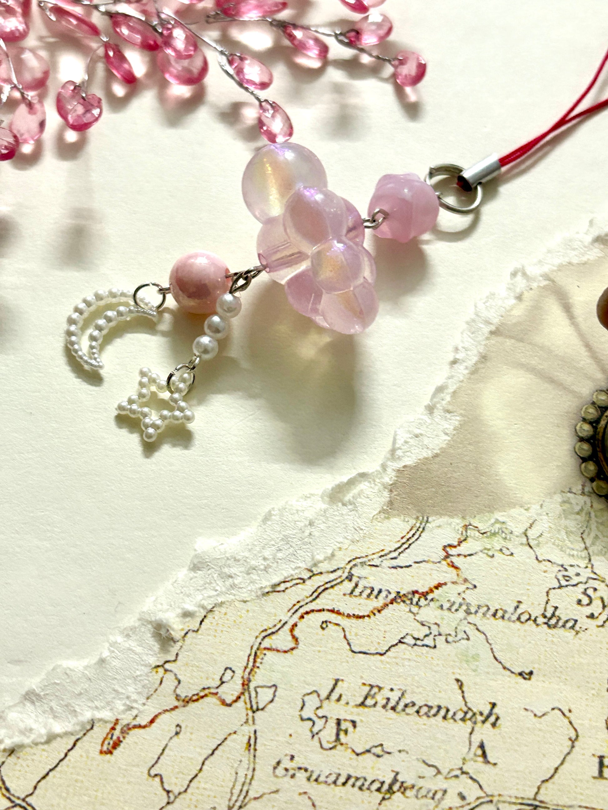 Aesthetic beaded phone charm with cloud-shaped beads, moon and star danglers, and pearls. A soft dreamy accessory for phones, bags, or gifting.
