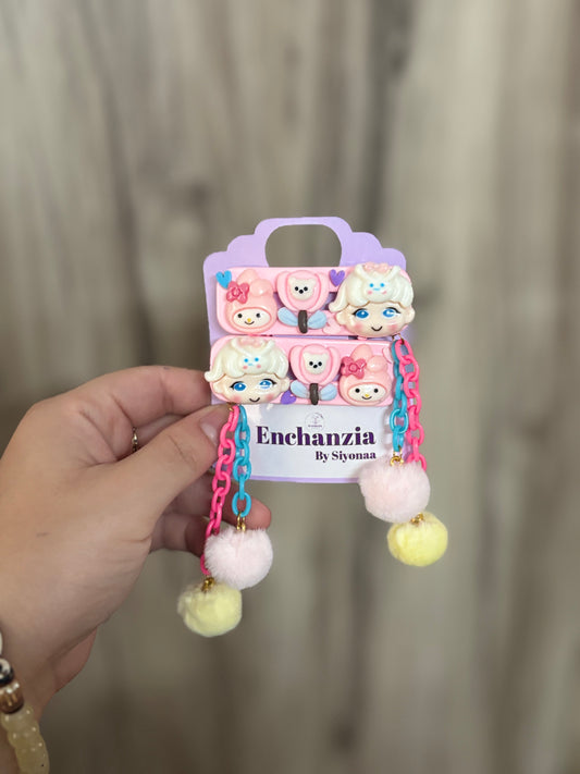 Set of My Melody-themed hair clips with pink and blue chains, fuzzy pom pom dangles, and cute cartoon faces—ideal for playful, fun hairstyles for kids.
