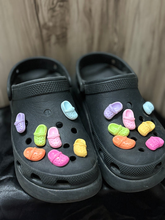 Colorful Crocs-shaped Jibbitz charms in matching pairs, with vibrant shades like pink, blue, yellow, black, and more—perfect for a quirky Crocs upgrade.
