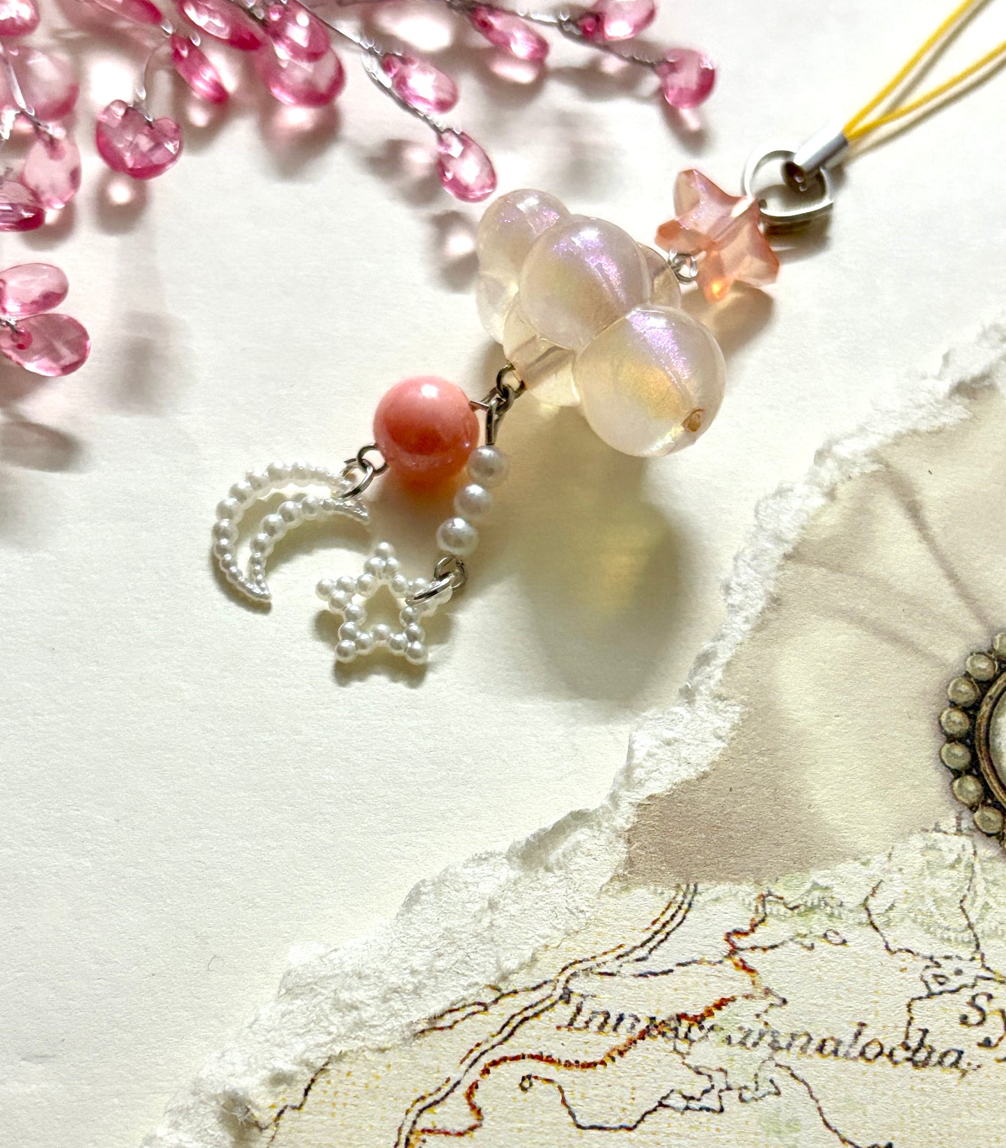 Aesthetic beaded phone charm with cloud-shaped beads, moon and star danglers, and pearls. A soft dreamy accessory for phones, bags, or gifting.
