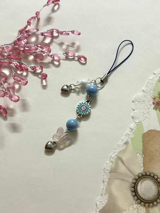 Silver evil eye phone charm keychain with protective symbol, perfect for phones. Trendy, aesthetic and lucky—ideal for girls, teens & anyone who loves cute accessories.
