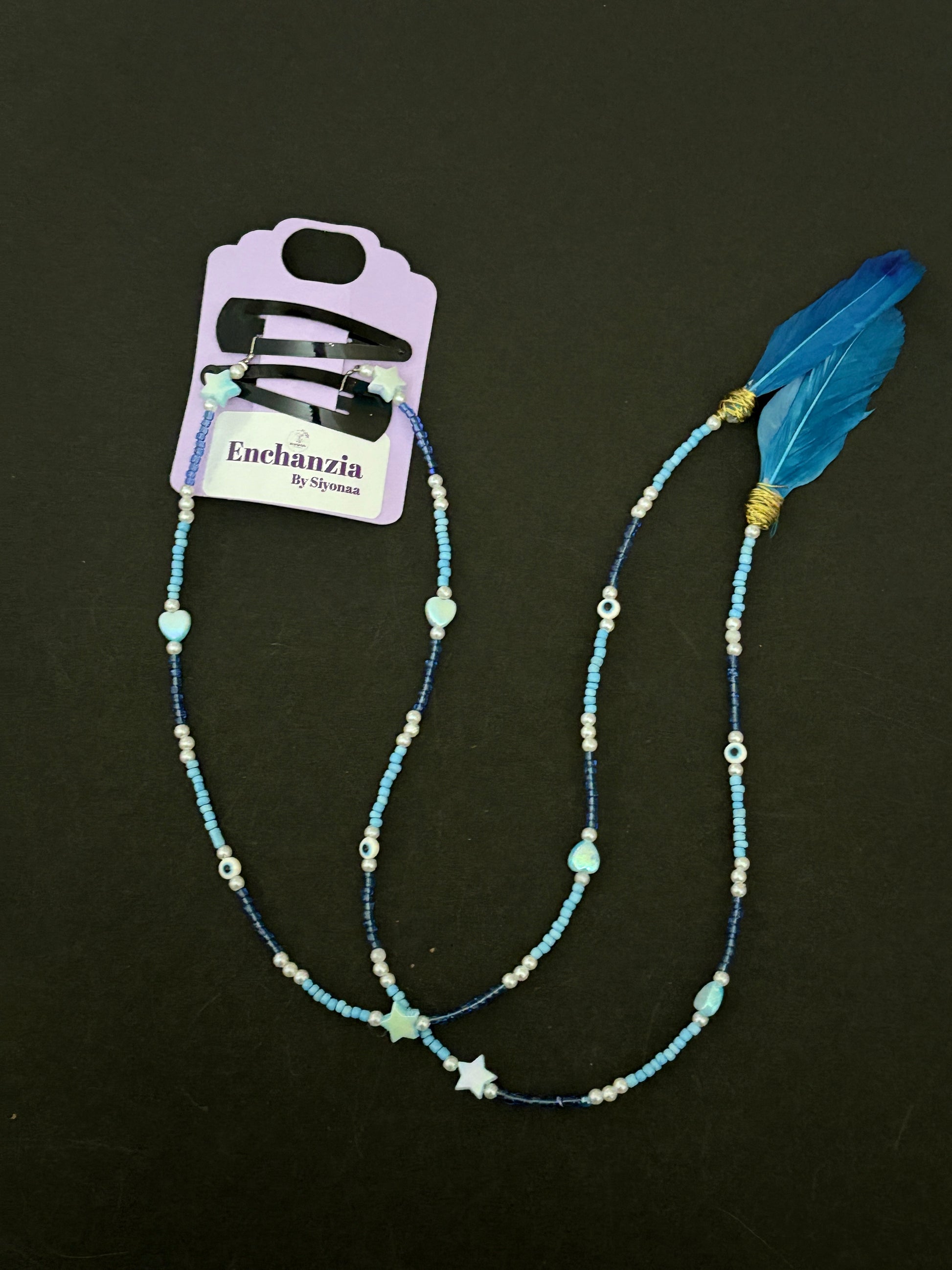 A handmade bohemian-style hair braid decorated with small beads and shaped charms, clipped into natural hair for a free-spirited, festival-ready look.
