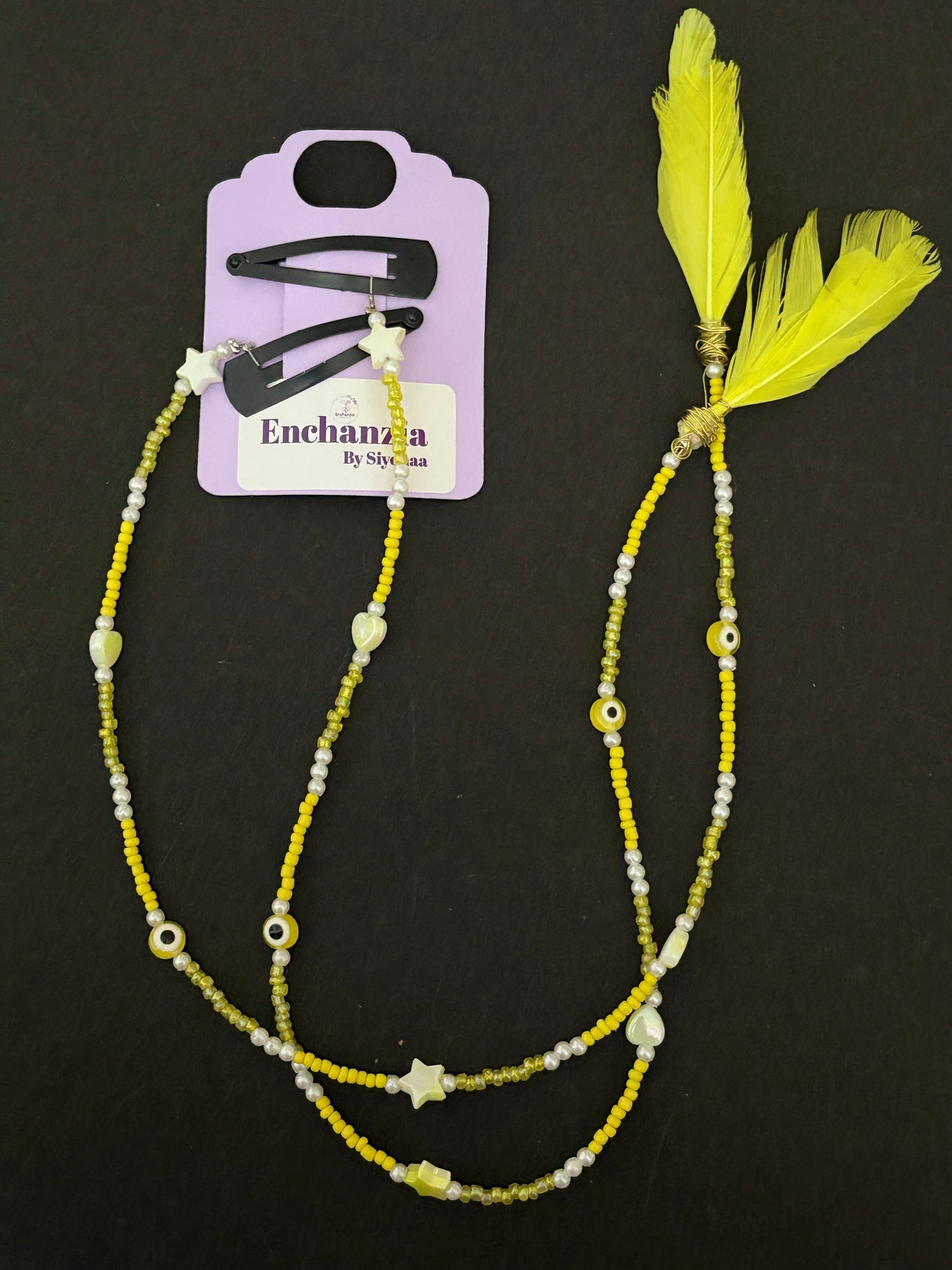 A handmade bohemian-style hair braid decorated with small beads and shaped charms, clipped into natural hair for a free-spirited, festival-ready look.

