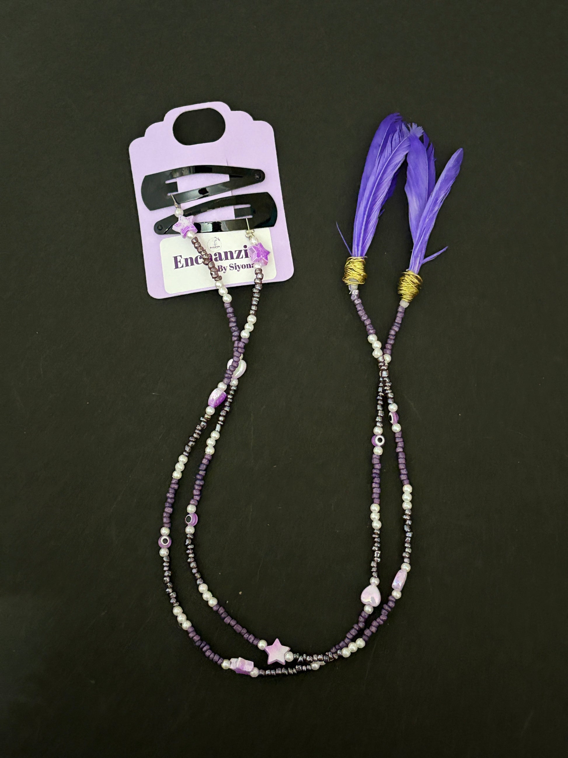 A handmade bohemian-style hair braid decorated with small beads and shaped charms, clipped into natural hair for a free-spirited, festival-ready look.
