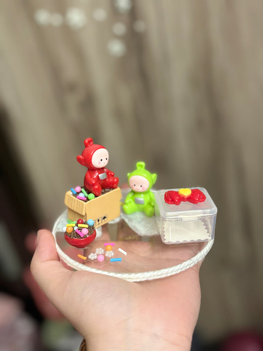 A handmade miniature platter featuring cartoon-inspired characters with playful accessories and candy-themed details, designed for holding small items like rings, earrings, toffees, or trinkets; perfect for decor or gifting.