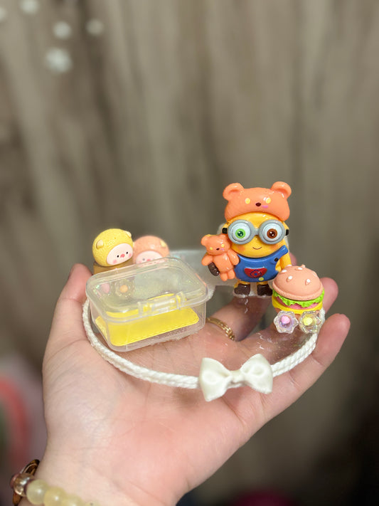 A handcrafted miniature platter featuring a minion-inspired character and cute accessories, designed for holding small items like rings, earrings, toffees, or trinkets; ideal as a decorative tabletop organizer or gift.
