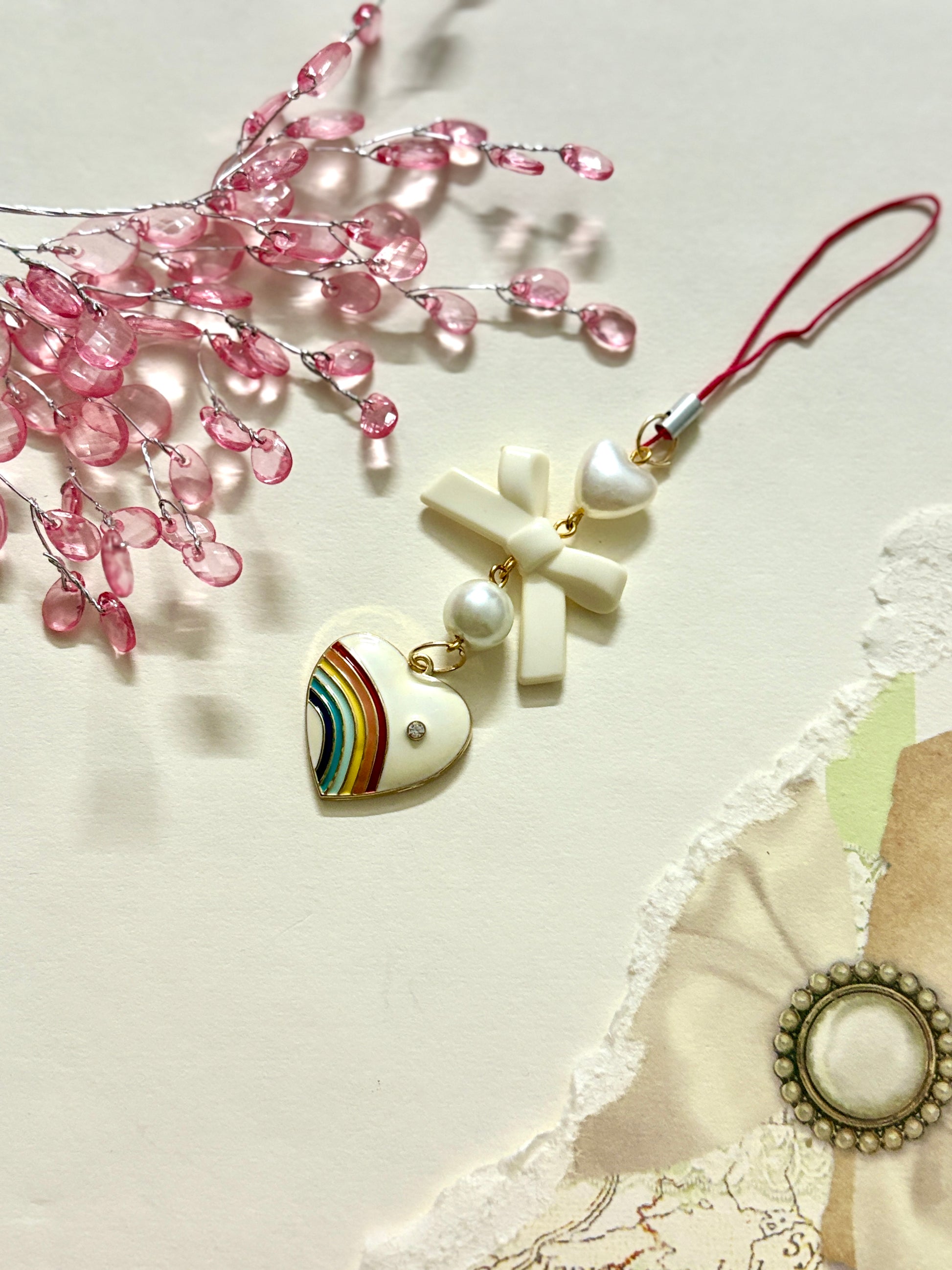 Rainbow pride heart phone charm with cross, heart, and round beads — a colorful and meaningful accessory available in four unique variations.