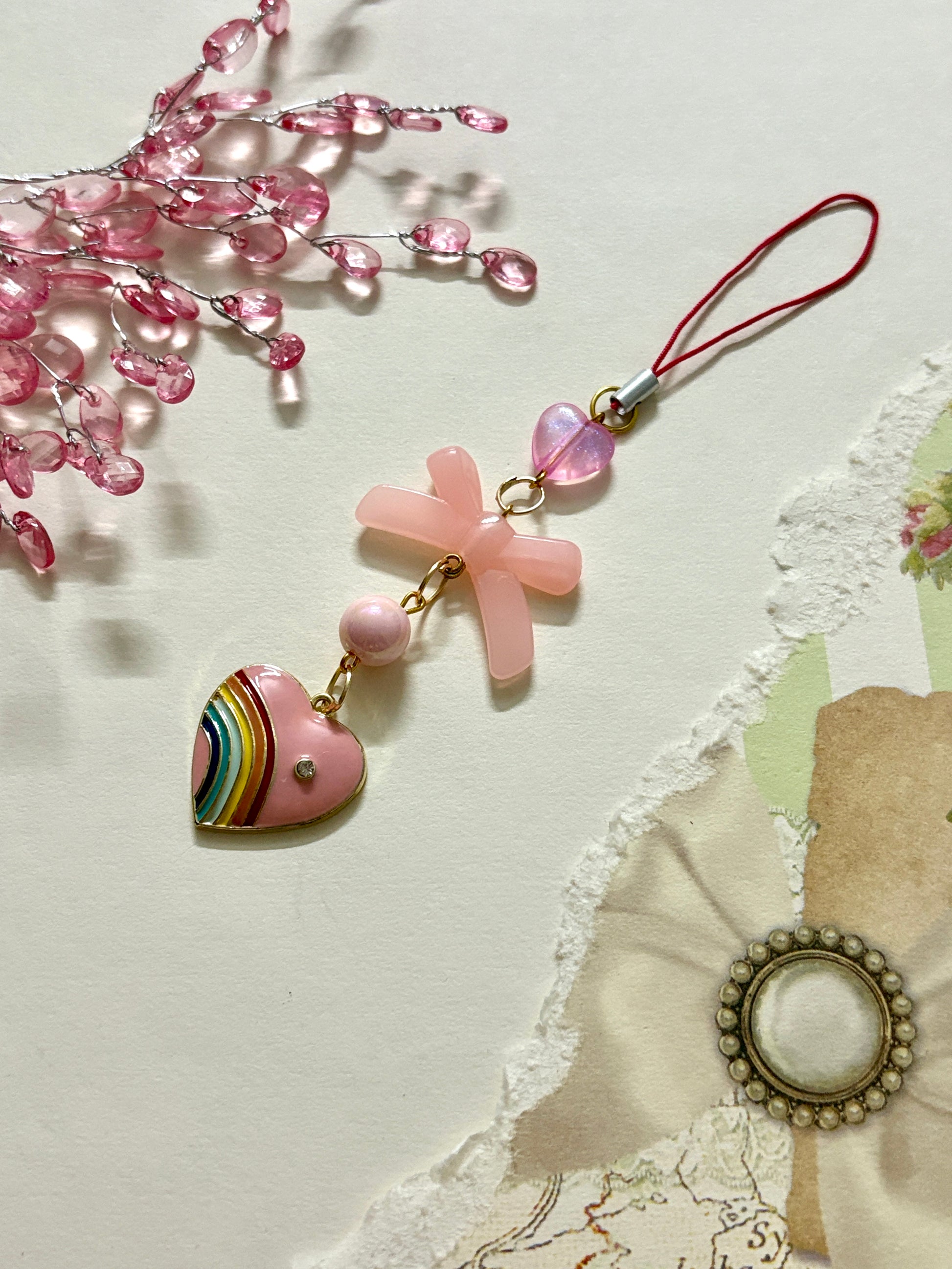 Rainbow pride heart phone charm with cross, heart, and round beads — a colorful and meaningful accessory available in four unique variations.